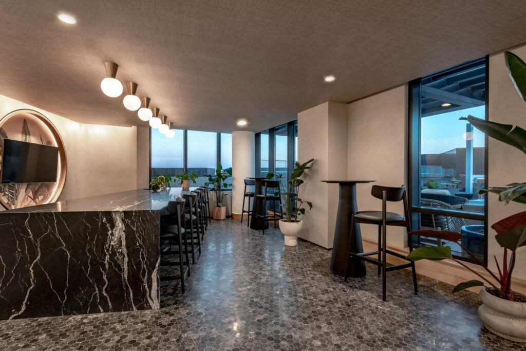 The Cream of the Crop - rooftop lounge with luxury chairs, countertops, and great views